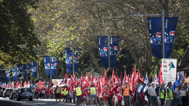 People walk down Elizabeth Street during the May Day rally in Sydney on May 6 this year. 