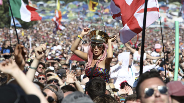 Revellers react to Kylie Minogue as she performs at the Glastonbury Festival. 