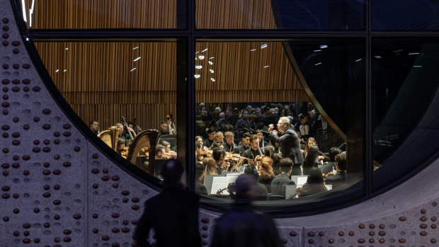 'Portholes' in the Melbourne Conservatorium of Music allow passers-by to peer in and observe a performance.