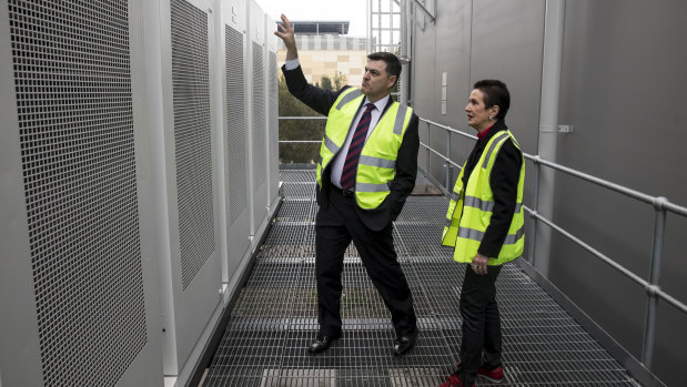 CEO of Transgrid, Paul Italiano, shows lord mayor Clover Moore the new Tesla Battery installed at the Alexandra Canal Depot.