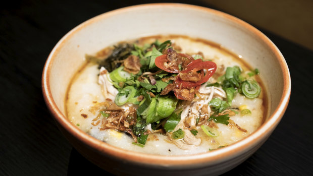The chicken and mushroom congee is topped with fried leek, garlic and a swig of sesame oil and soy. 