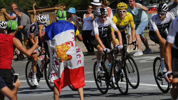 Unwanted attention: Chris Froome, centre in white, has been on the receiving end of abuse from spectators.