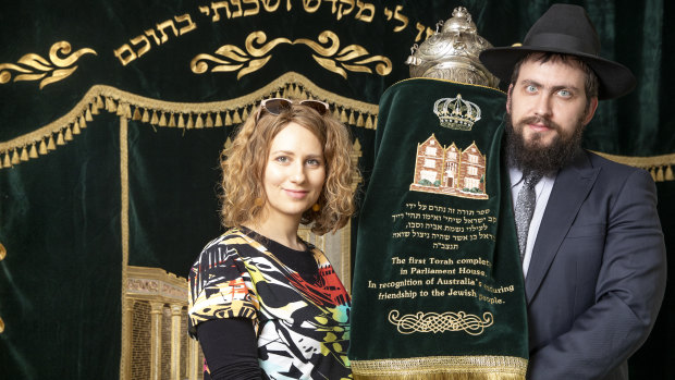 Rebbetzin Chasia Feldman and Rabbi Shmueli Feldman with the Torah at Chabad ACT. 