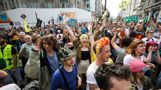 Climate activists dance during a protest at the intersection near Oxford Circus London Underground station on Wednesday.