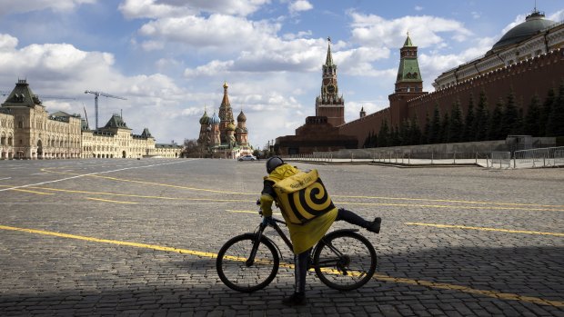 A food delivery courier rides his bicycle in the Red Square in Moscow last week.