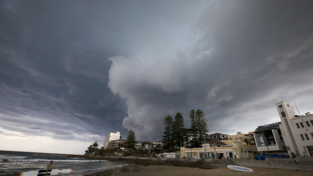 A storm rolls into Cronulla beach, where Reserve Bank research shows climate change could increase the cost of property insurance. 