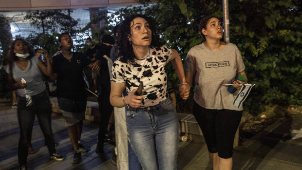 Jewish nationalist demonstrators looking at a barrage of rockets fired from the Gaza Strip toward central Israel, in the Israeli town of Ramla. 