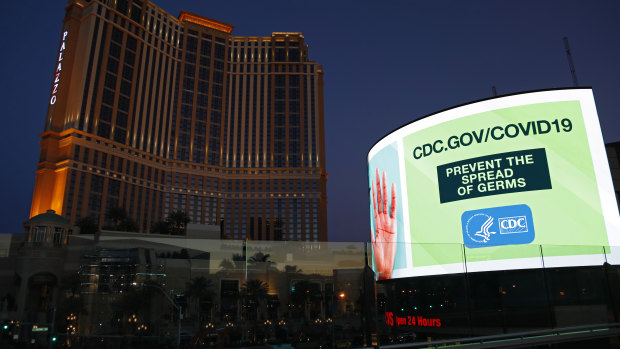 A sign advises people to minimized the spread of germs, along the Las Vegas Strip devoid of the usual crowds during the coronavirus outbreak Tuesday, May 26, 2020, in Las Vegas.