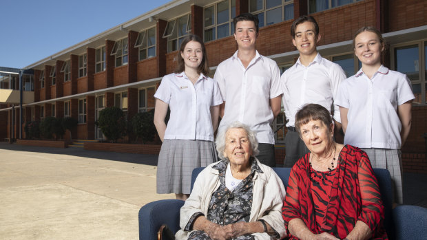 The first female teachers at Daramalan College (Jean Reid, 102, and Mary Barton, 77, on Friday with Year 12 students Rosie Coleman, Josh Low-McMahon, Corey Goodberg, and Abby Thomas. They are outside the teaching wing named in Mrs Reid's honour.