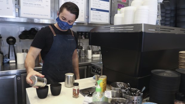 Barista Will Hobbs wearing a mask at work on the northern beaches. 