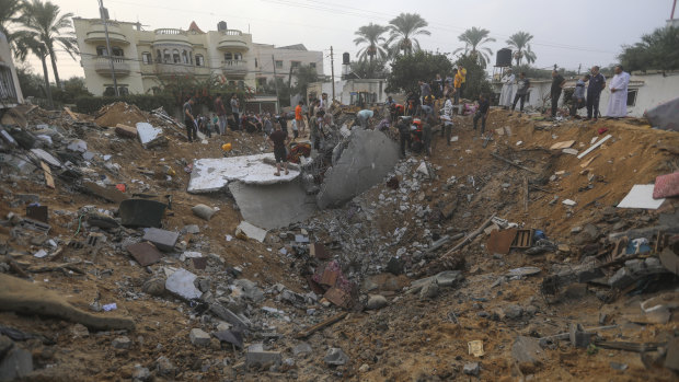 Palestinians inspect the damage caused by an Israeli airstrike on a house in Khan Younis, southern Gaza Strip.