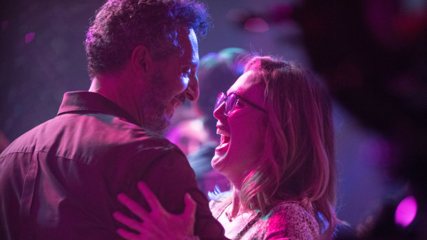 Julianne Moore dances with Arnold, an adventure park owner played by John Turturro in Gloria Bell.