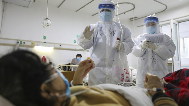 Medical workers check on the conditions of patients in Jinyintan Hospital, designated for critical COVID-19 patients, in Wuhan.