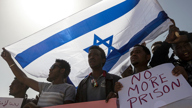 Asylum seekers march during a protest outside Israeli Prison Saharonim, in the Negev desert, southern Israel, in February.