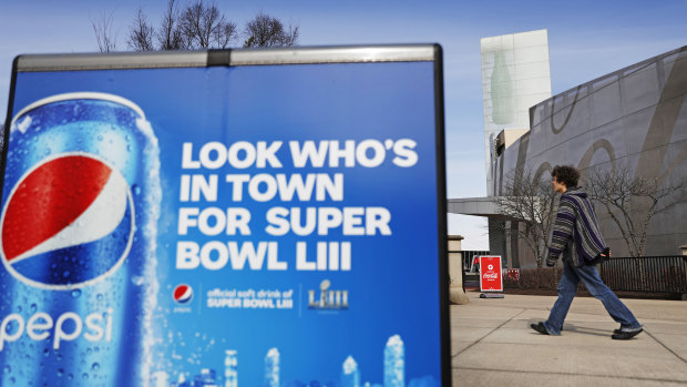 Cola wars: A Pepsi advertisement stands outside the World of Coca-Cola museum in Atlanta, site of this year's Super Bowl.