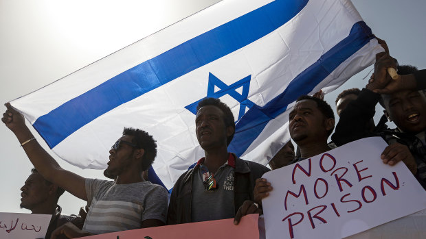 Asylum seekers march during a protest outside Israeli Prison Saharonim, in the Negev desert, southern Israel.