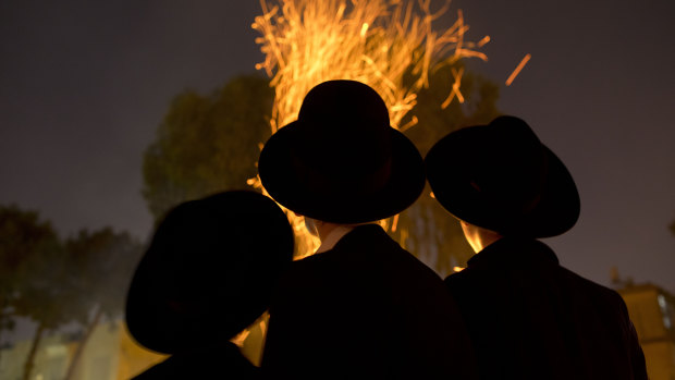 Ultra-Orthodox Jews gather next to bonfires during the Jewish holiday of Lag Ba'Omer in Israel last week. Avigdor Lieberman accused Netanyahu of "capitulating to the ultra-Orthodox".
