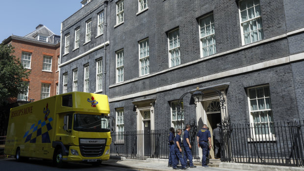 Removalists enter 10 Downing Street on Thursday as Boris Johnson moves in.