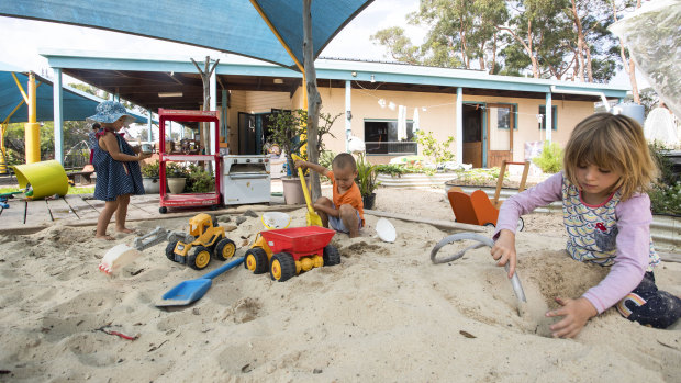 Audrey Wood-Ingram, Finn Weiland and Caitlyn Weiland play in the sand pit at the Mallacoota preschool.