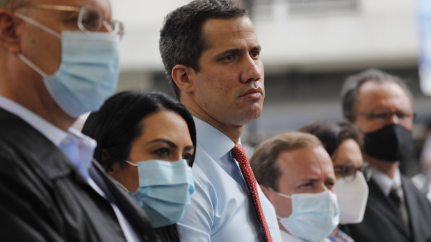 Flanked by party members, Venezuelan opposition leader Juan Guaido, centre, stands during a press conference, a day after parliamentary elections. Guaido is recognised by dozens of countries as the president of Venezuela.