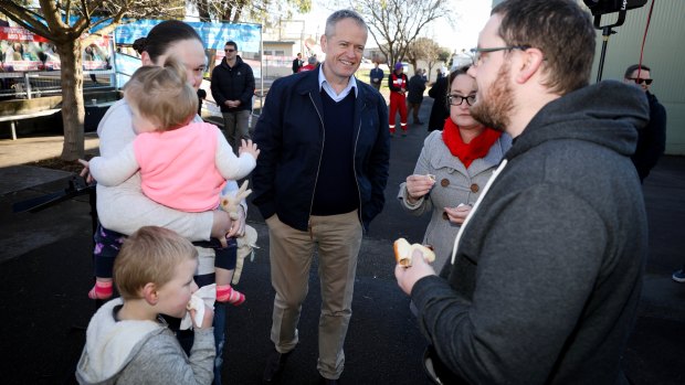 Democracy sausages abound as Bill Shorten and Labor candidate for Braddon Justine Keay visit a Devonport polling station on Saturday.