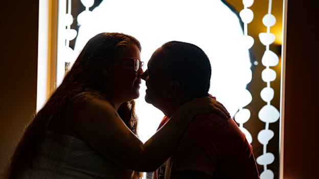 Fiona and James share a smooch at the place they met - Dickson Tradies.