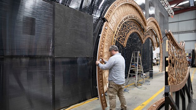 Crew install the heart-shaped portal that forms the centrepiece of Moulin Rouge! The Musical!