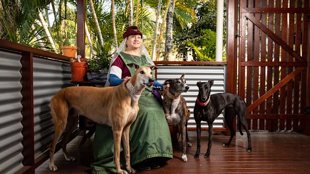 Susan Cooper – in her noblewoman outfit – at her Gold Coast home with her three greyhounds (from left) Rory, Lucy-lou and Marley.