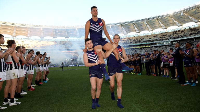 Hanging up the boots: Fremantle's Michael Johnson is chaired from the ground between a guard of honour after playing his final game, against Collinwood in round 23.