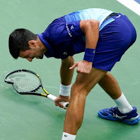 Novak Djokovic smashes his racket on the court after losing a point to Daniil Medvedev.