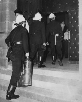 Emergency services workers enter the cathedral. 