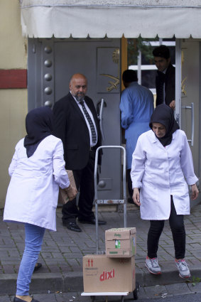 Cleaning personnel enter Saudi Arabia's Consulate in Istanbul.
