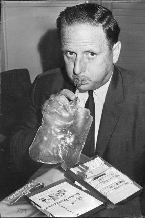 The NSW Transport Minister, Mr. Milton Morris, who is teetotaller, demonstrates the use of a breath tester on March 10, 1968.