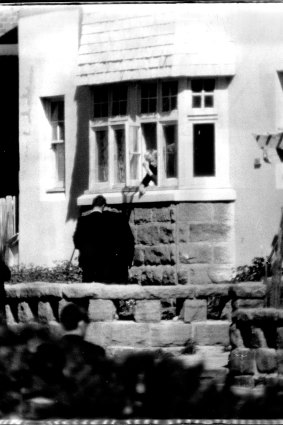 Police run forward to grab the rifle which had been dropped from the window by a man. September 9, 1969.