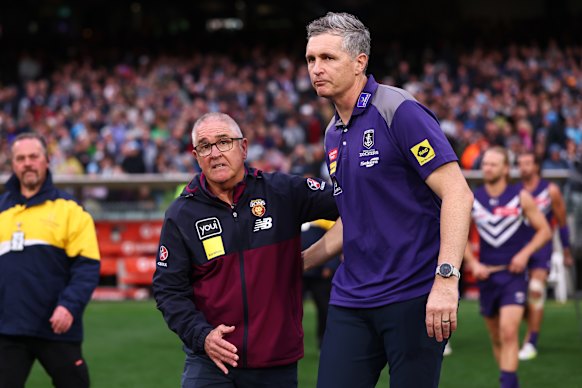 Brisbane coach Chris Fagan consoles his opposite number, Justin Longmuir, after the siren.