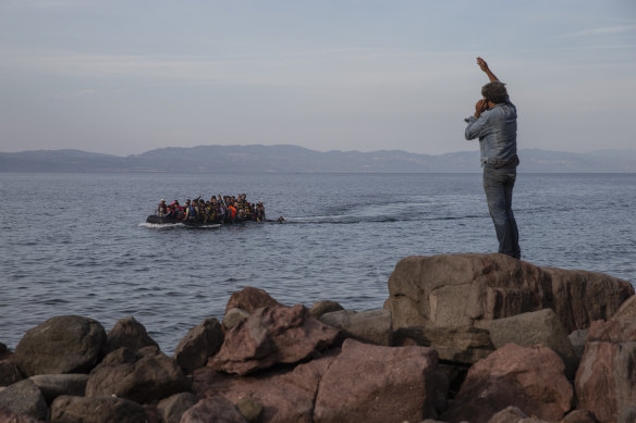 Refugees and migrants aboard an overcrowded dinghy cross the Aegean Sea, from Turkey to the coast of Lesbos island, Greece in 2015. Greek authorities have invited private contractors to bid on supplying a 2.7-kilometre floating barrier.