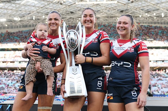 The retiring Millie Elliott, daughter Gigi, Olivia Kernick and Keeley Nizza with the premiership trophy.