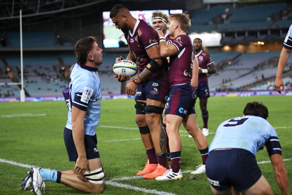 Lukhan Salakaia-Loto scores for the Reds in a big win over the Waratahs at a sparsely attended ANZ Stadium.