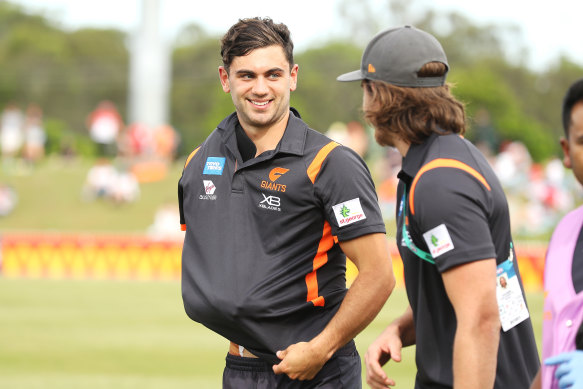 Tim Taranto was all smiles at quarter-time, but the Giants face an anxious wait to learn how bad his shoulder injury is.