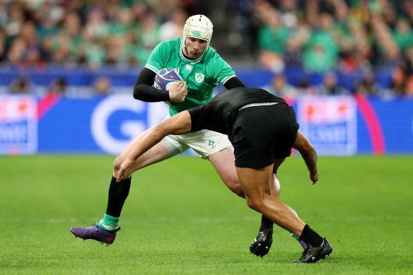 Mack Hansen of Ireland is put under pressure by Leicester Fainga’anuku of New Zealand.