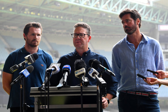 Paul Marsh, flanked by Patrick Dangerfield and Gillon McLachlan at an AFL media conference.