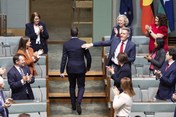 Treasurer Jim Chalmers is congratulated by colleagues after delivering the budget speech.
