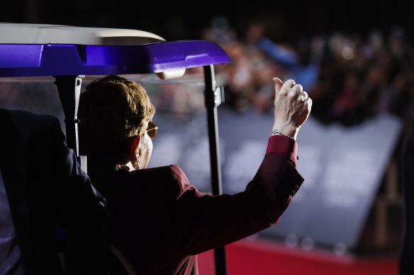 Elton John waves from a purple golf cart which delivered him to the red carpet in Toronto.