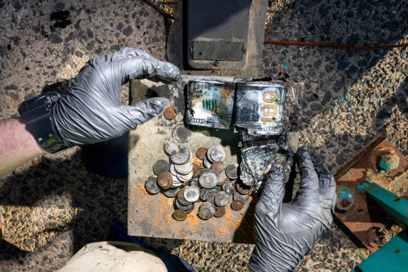 Kane shows some of the cash he found in a safe he fished out of a creek.