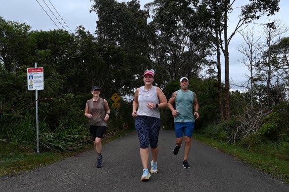 Warringah Independent MP Zali Steggall (centre) with running partner Susan Robertson (left) and husband Tim Irving (right) train for the 80-kilometre Bondi to Manly ultra marathon.