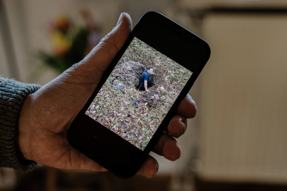 laas Tammes, the former mayor of the municipality that includes Ommeren, Netherlands, shows a picture he took of a man digging for treasure buried by the Nazis in the 1940s.