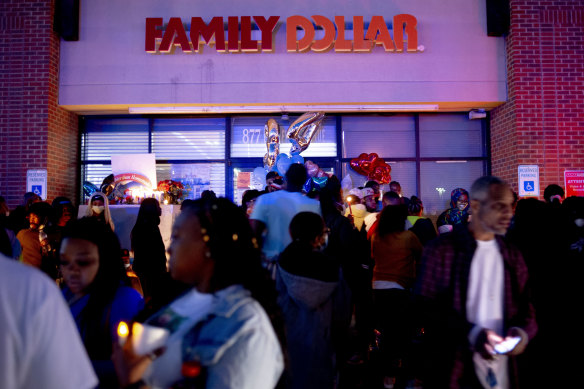 People mourn outside the Family Dollar store in Flint, Michingan.