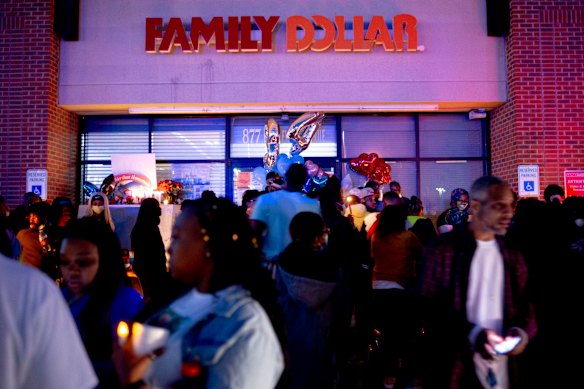 People mourn outside the Family Dollar store in Flint, Michingan.