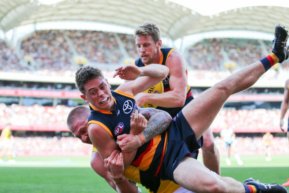 The Crows Patrick Parnell is slung to the ground by Nathan Broad.