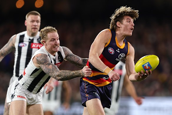 Josh Worrell of the Crows and Beau McCreery of the Magpies.